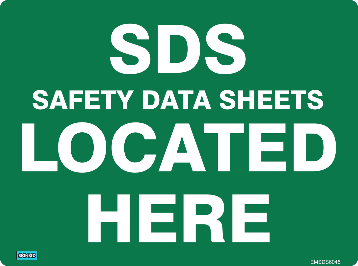A green Emergency Information Sign with white text reads "Emergency Safety Ds Located Here," clearly indicating the location of this essential safety equipment.