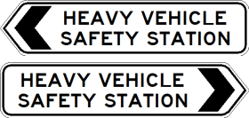 Two G9-247-1n Heavy Vehicle Safety Station signs are shown: the top with a left-pointing black arrow, the bottom with a right-pointing arrow. Both have black text on white backgrounds.