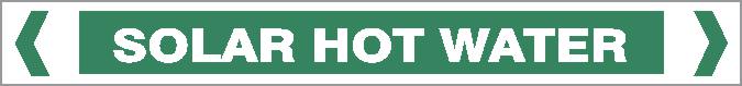 A rectangular green "Pipe Marker - WATER - SOLAR HOT WATER" sign features bold white text, white borders, and angled brackets on each side.