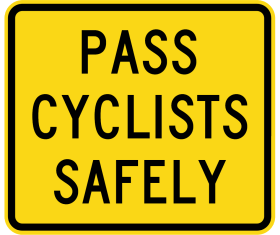 The W8-253n - Pass Cyclist Safely is a rectangular yellow road sign with a black border showing “PASS CYCLISTS SAFELY” in bold, black letters.
