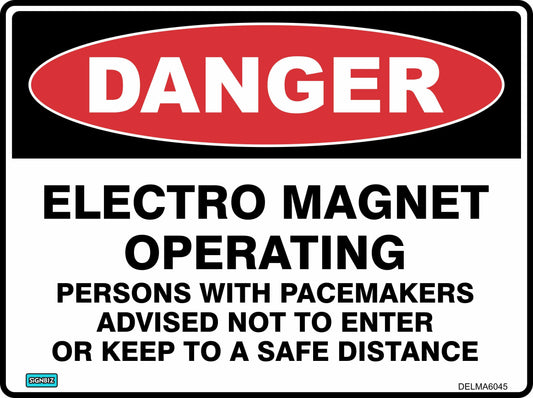 The "Danger Electro Magnet Operating" sign warns: "DANGER ELECTRO MAGNET OPERATING. PERSONS WITH PACEMAKERS ADVISED NOT TO ENTER OR KEEP TO A SAFE DISTANCE." The word "DANGER" appears in white on a red oval for maximum visibility.