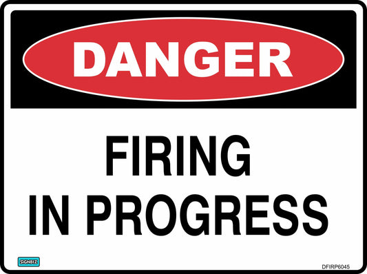 The "Danger Firing In Progress" sign meets AS/NZ 1319-1994 standards, with a red oval labeled "DANGER" above bold black "FIRING IN PROGRESS" text on a white background.