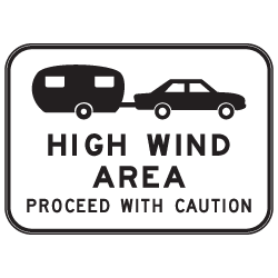 The G6-202n sign features a car and caravan above "HIGH WIND AREA PROCEED WITH CAUTION" in bold black on white.