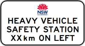 A road sign labeled G9-248-5n with the NSW Government logo reads: "HEAVY VEHICLE SAFETY STATION __km ON LEFT," indicating the distance to the safety station.