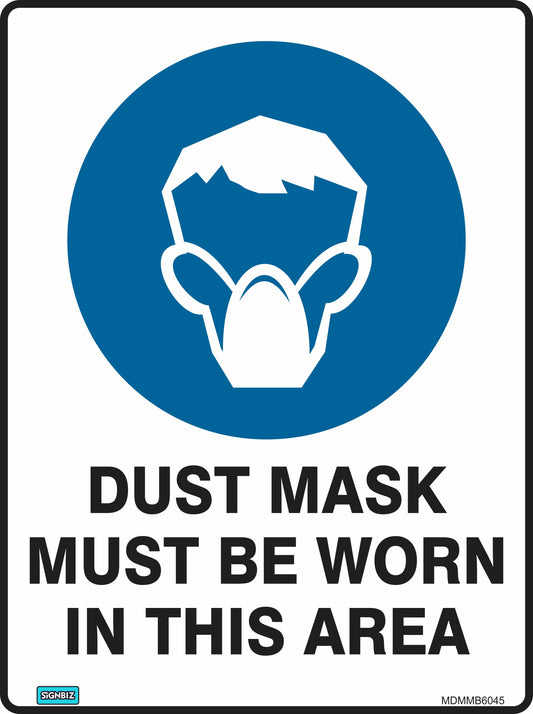 The Mandatory Dusk Mask Req sign features a blue circle with a white outline of a person wearing a dust mask and bold text: "DUST MASK MUST BE WORN IN THIS AREA." Perfect for clear workplace safety communication.