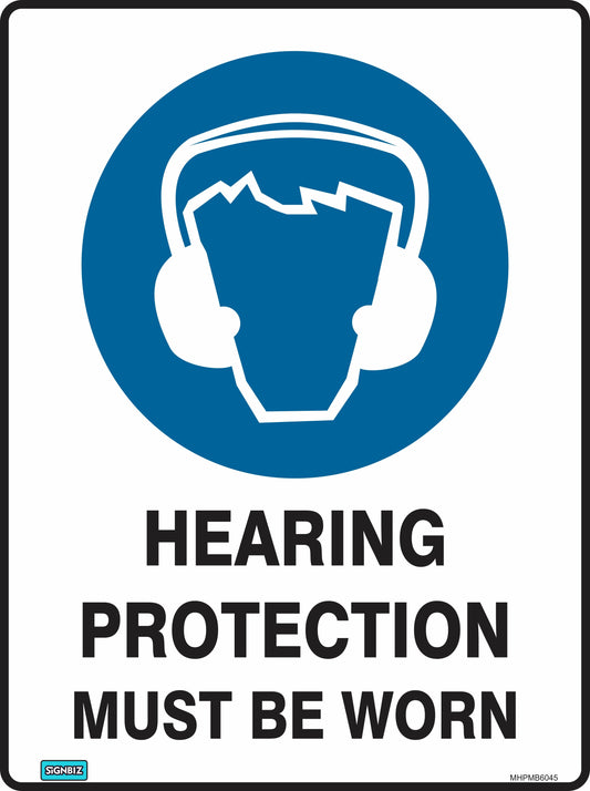 The “Mand Hear Prot Must Be Worn” sign features a blue and white icon of a person in earmuffs, with bold black text stating, “HEARING PROTECTION MUST BE WORN,” to highlight essential workplace safety.