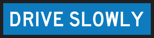 The Drive Slowly (MMS Insert) is a blue rectangular sign with bold white capital letters and a black border, designed for sign frames to allow easy insertion and interchange of messages.