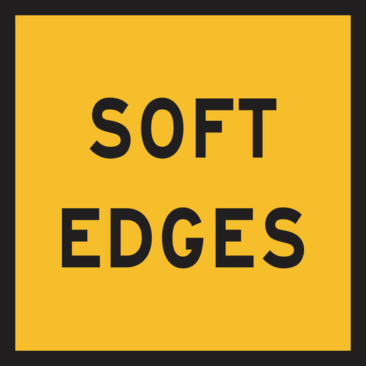 A yellow rectangle with a thick black border displays "SOFT EDGES" in bold black capitals—ideal as a Soft Edges (MMS Insert) for Multi-Message Sign systems, enabling quick message changes for effective traffic guidance.