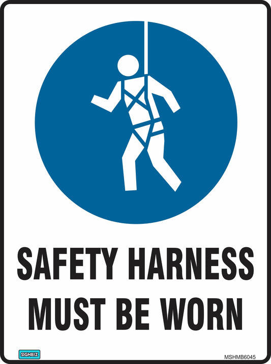 The Mand Safety Harness Must Be Worn sign features a blue circle with a stick figure wearing a harness on a line, and bold text: "SAFETY HARNESS MUST BE WORN." It promotes workplace safety and ensures employee protection on site.