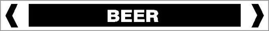 A rectangular black pipe marker labeled "Pipe Marker - OTHER LIQUID - BEER" features white borders, centered white text reading "BEER," and double angle brackets on each side.