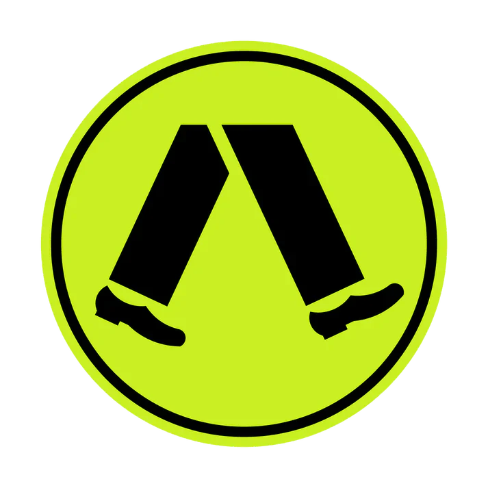 A circular yellow-green R3-1 Pedestrian Crossing (Symbolic) sign with a black border features two black walking legs with shoes, commonly used in NSW to promote road safety at pedestrian crossings.