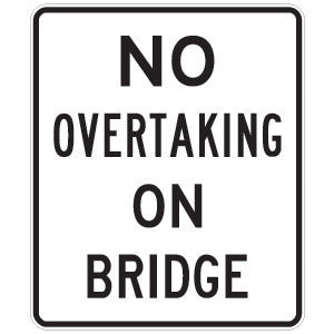 The R6-2 No Overtaking On Bridge sign is a rectangular Australian Standards road sign with a white background, black border, and bold uppercase black letters stating "NO OVERTAKING ON BRIDGE.