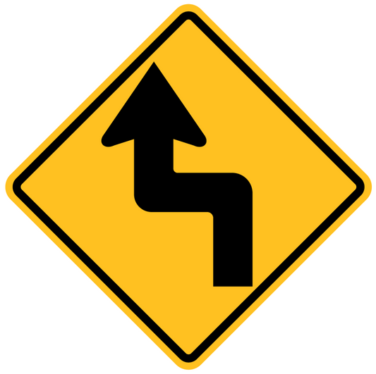 The W1-2(L) Reverse Bend (Left Symbolic) sign is a yellow diamond-shaped road sign featuring a black arrow showing a left turn followed by a right turn ahead.