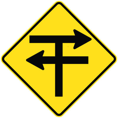 The W2-201n - T-Junction With Dual Carriageways (Symbolic) sign is a yellow diamond-shaped road sign with black arrows indicating a T intersection where turns are required.