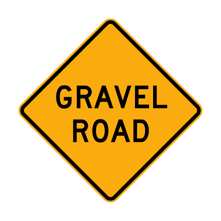 The W5-19 - Gravel Road is a yellow, diamond-shaped traffic sign with "GRAVEL ROAD" in black text, warning drivers of an upcoming gravel road surface.