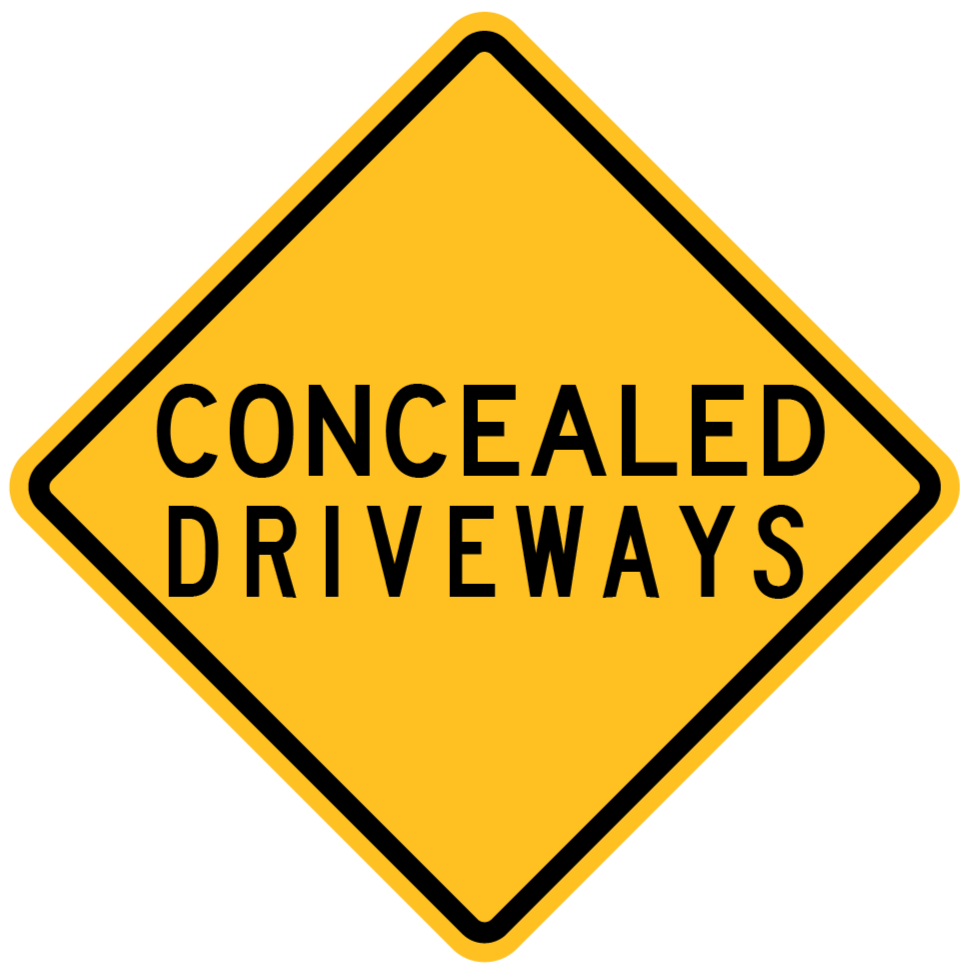 The W5-55-2n - Concealed Driveways sign is a yellow, diamond-shaped road sign with a black border that features the words "CONCEALED DRIVEWAYS" in large, black uppercase letters.