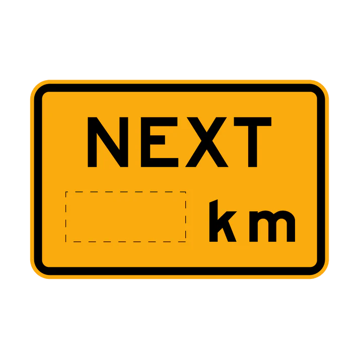 The W8-17-1 - Next (xx)km is a rectangular yellow road sign featuring "NEXT" at the top, an empty dashed box for customization, and "km" on the right side to indicate a variable distance.