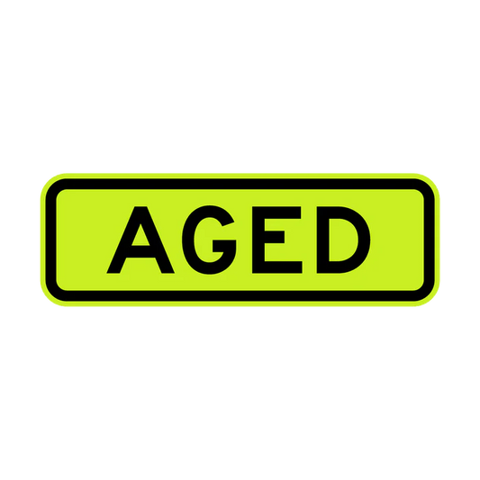 The W8-18 - Aged sign is rectangular, yellow-green with a black border, and features the word "AGED" in bold black capital letters at the center.