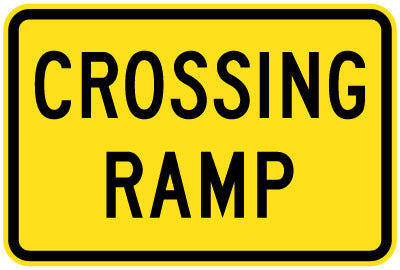 The W8-28 - Crossing Ramp is a rectangular yellow road sign with a black border and the words "CROSSING RAMP" in bold, black capital letters.