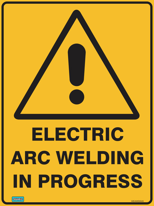 A yellow Warning Elect Arc Weld In Prog sign features a black exclamation mark in a triangle above bold text. It complies with AS/NZ 1319-1994 safety sign standards.
