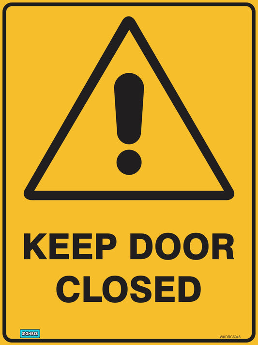 A yellow hazard warning sign with a black exclamation mark in a triangle above bold black text reading "WARNING KEEP DOOR CLEAR.
