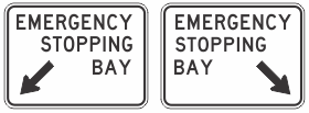 Two R5-59n Emergency Stopping Bay (L or R) signs, Australian Standard compliant, feature "EMERGENCY STOPPING BAY" in black on white. The left sign's arrow points down-left; the right, down-right.